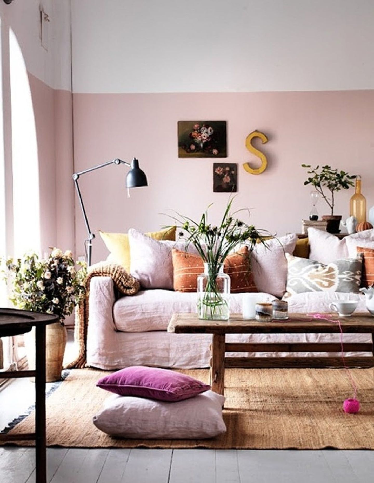 Sala com paredes pintadas meio a meio de branco e rosa clarinho.